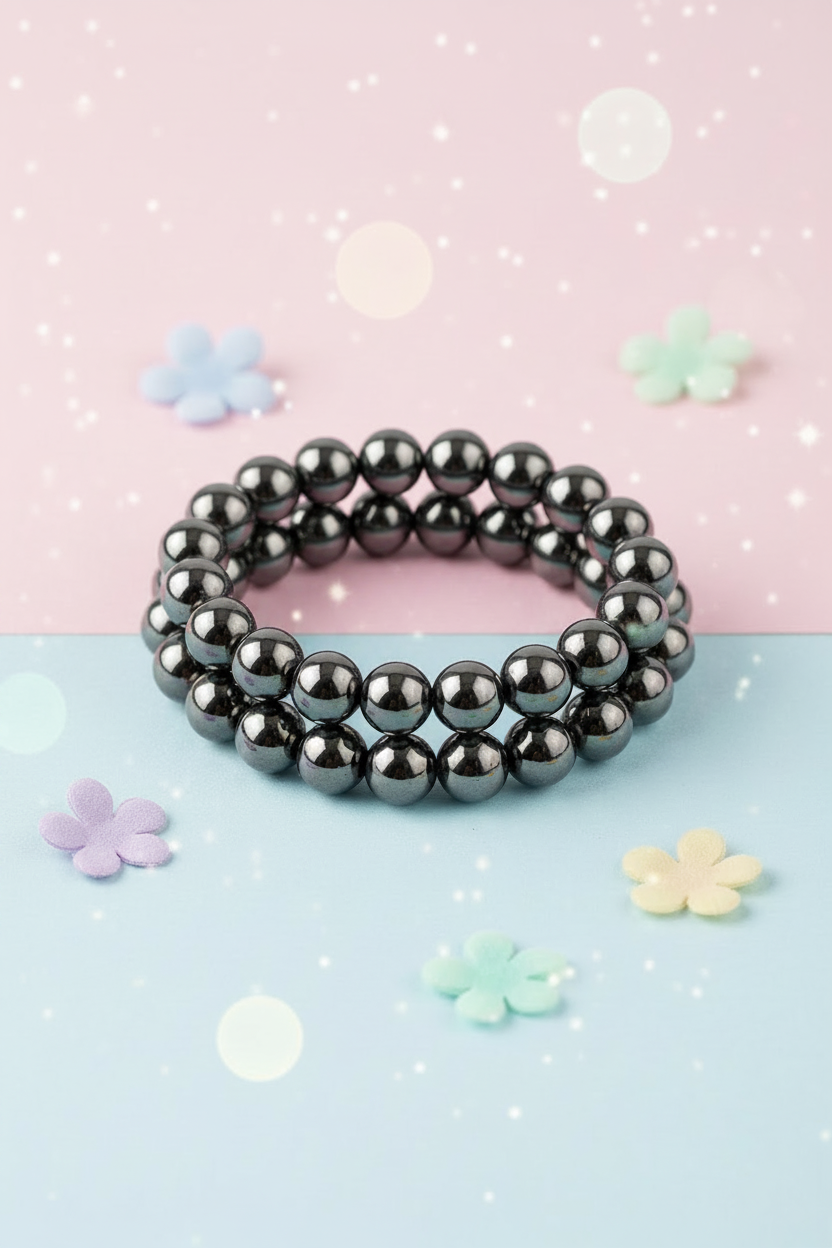 Black beaded bracelet on a pastel background with decorative flowers