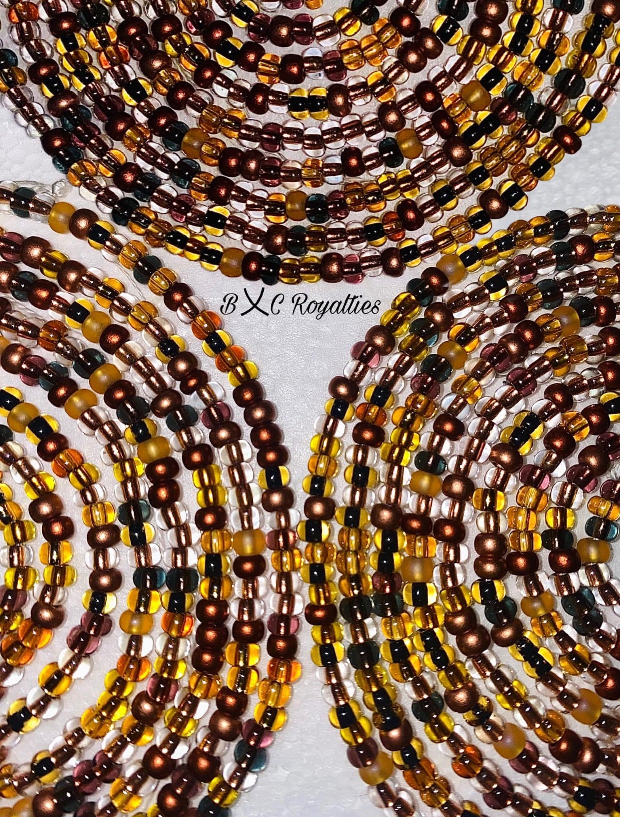 Beaded necklaces in brown, gold, and black on a white background with 'BXC Royalties' branding.