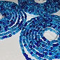 Blue beads on a string with a clear background