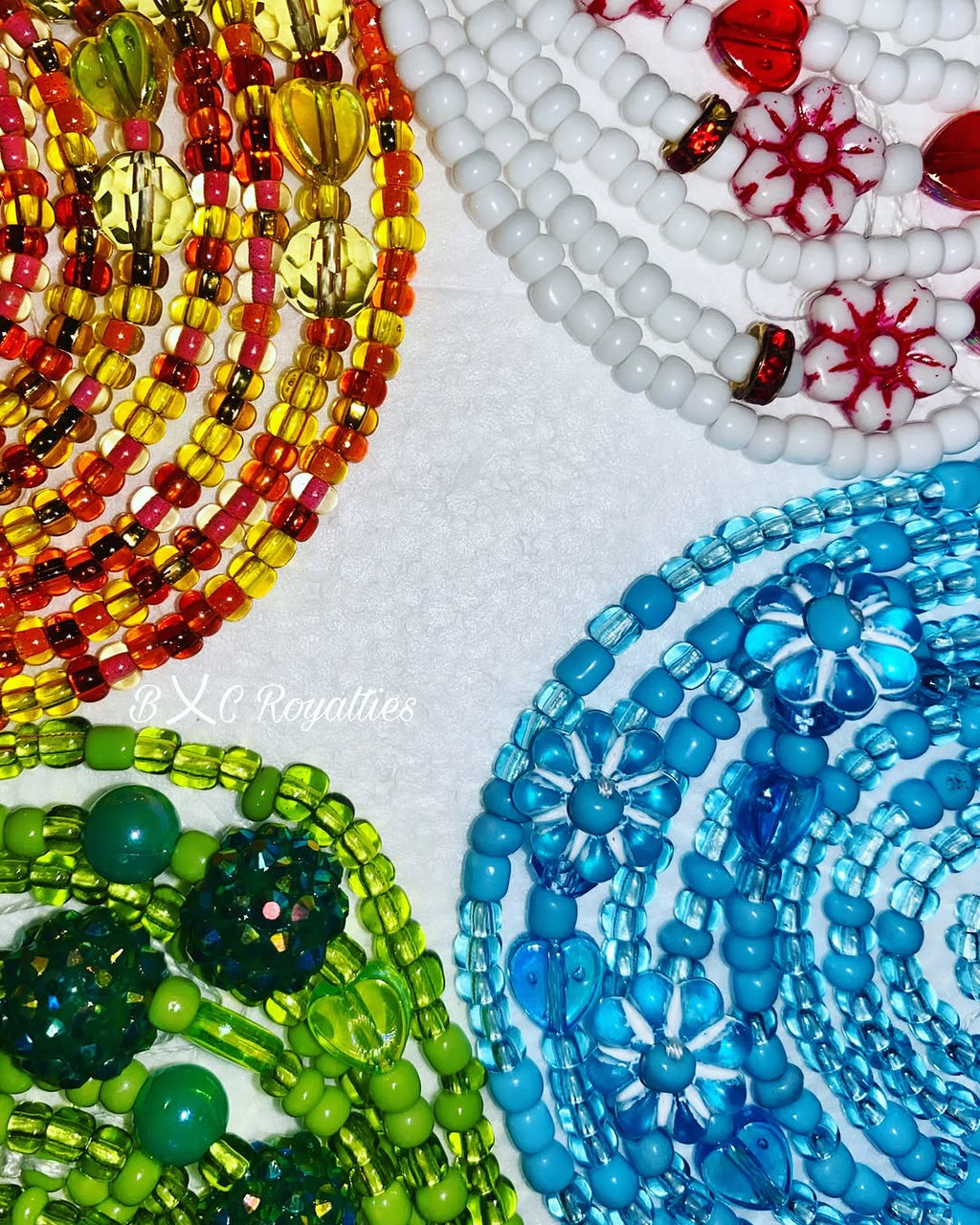 Close-up of colorful beaded waists on a white background