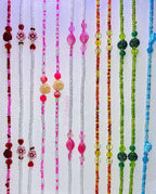 Colorful beaded waist-beads on a white background