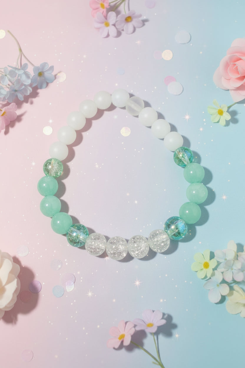 Beaded bracelet with green and clear beads on a white background