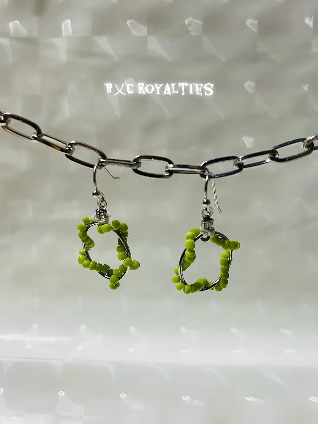 Lime Green beaded hoop earrings with a chain on a white background, branded 'BXC Royalties'.