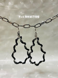 Black teardrop-shaped earrings on a chain against a neutral background with 'BxC Royalties' branding.