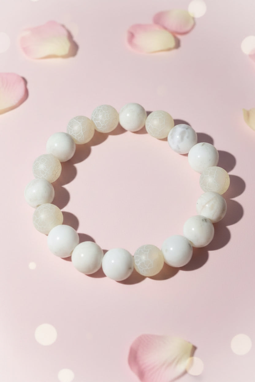 Beaded bracelet with white and gray stones on a light background