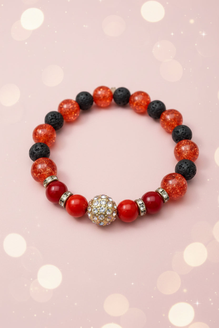 Bracelet with red, black, and silver beads on a white background