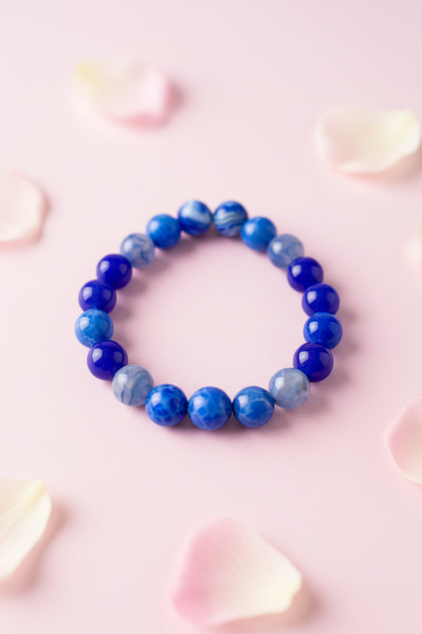 Blue beaded bracelet on a marble surface