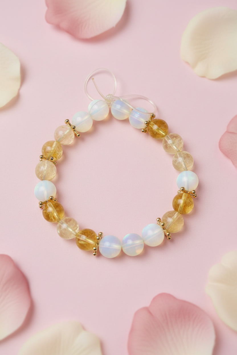 Beaded bracelet with yellow and white beads on a marble surface