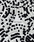 Close-up of black and white beaded pattern with 'BXC Royalties' branding.
