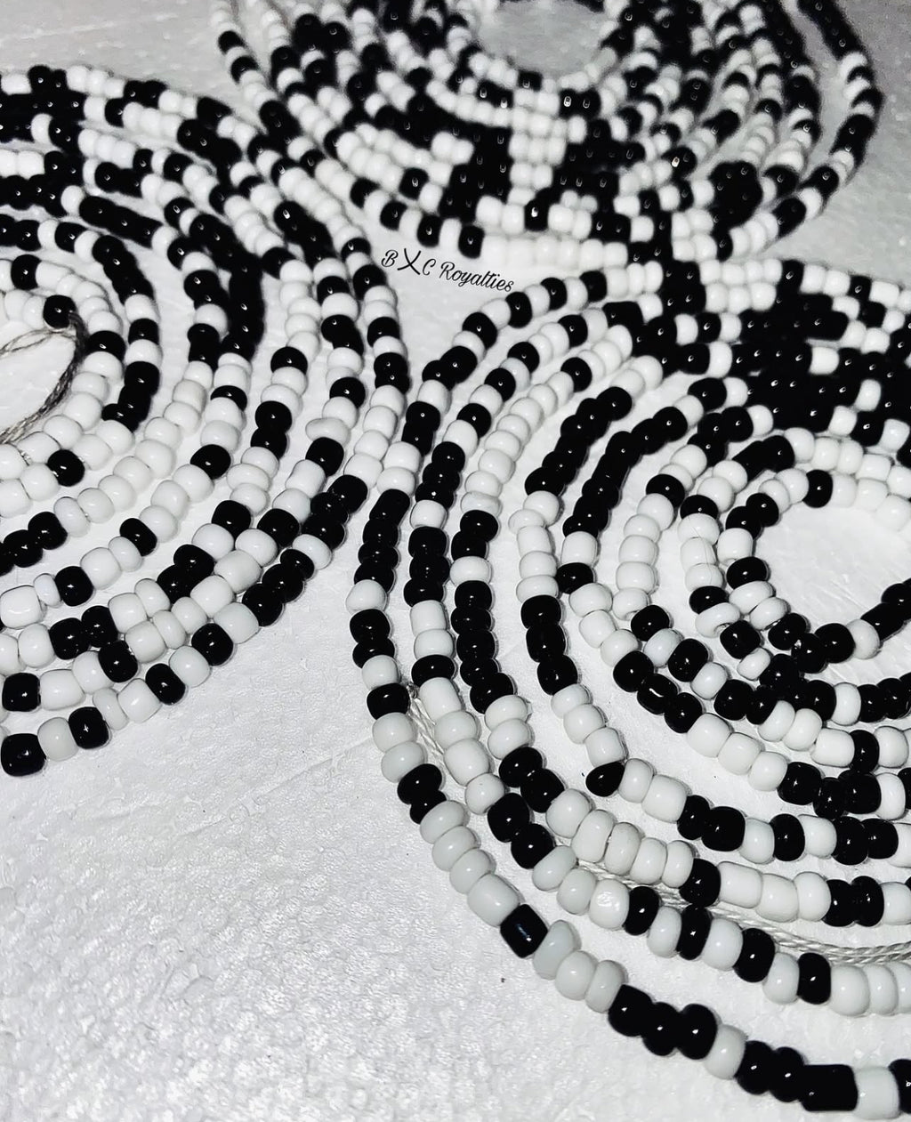 Black and white beaded necklace on a light background