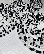 Black and white beaded necklace on a light background