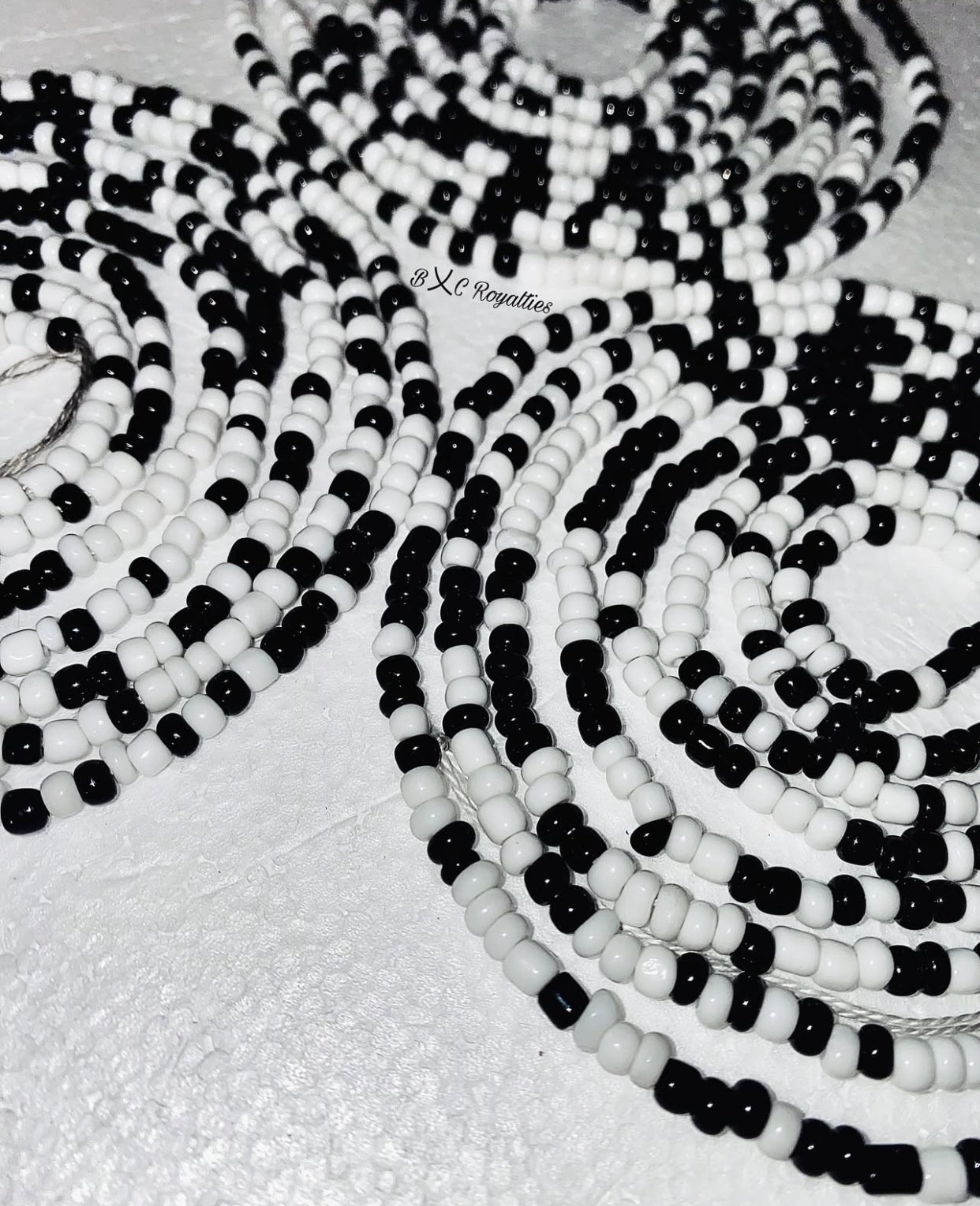 Black and white beaded necklace on a light background