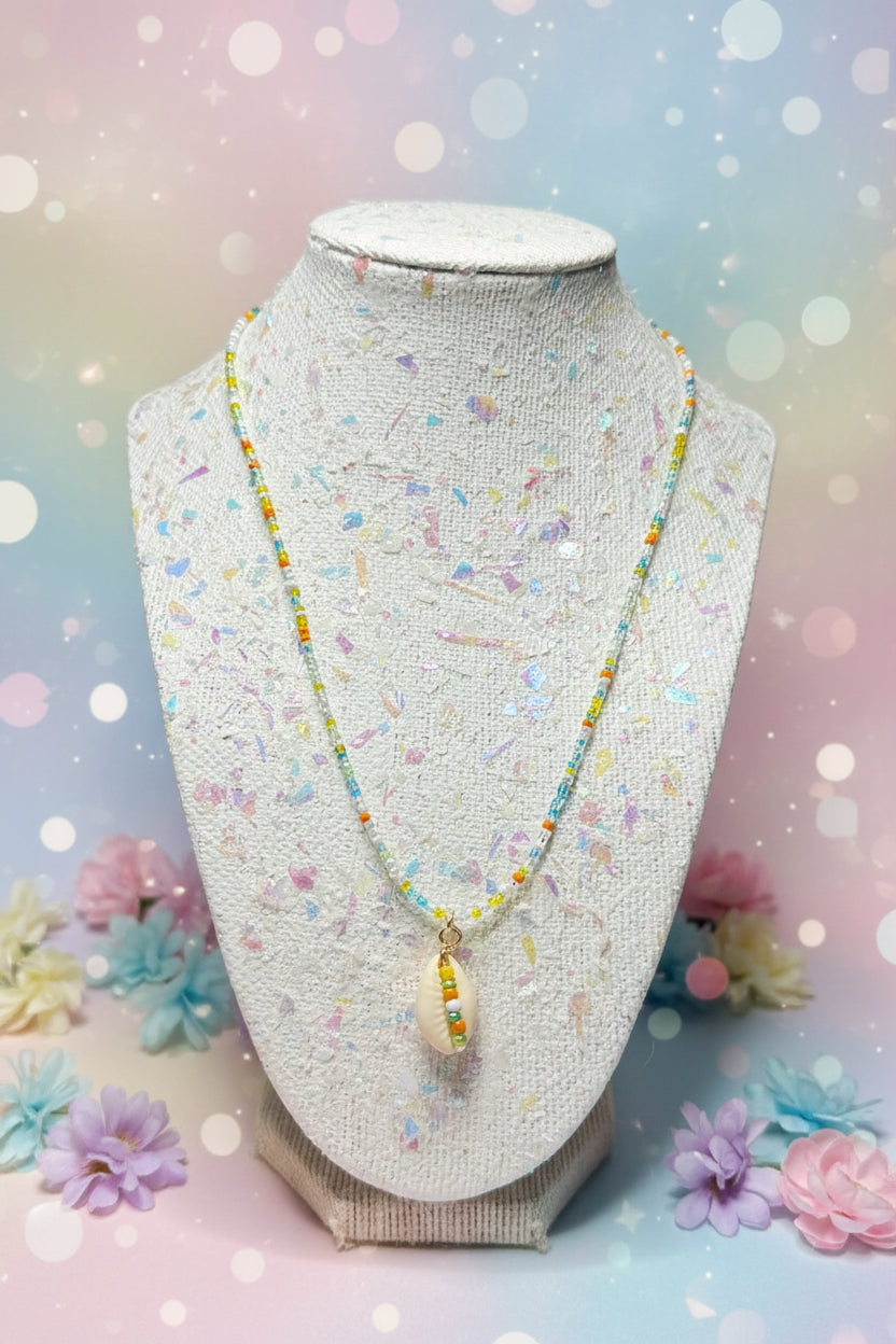 Beaded necklace on a textured stand with a blurred background