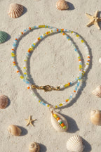 Necklace with shell pendant on a marble surface