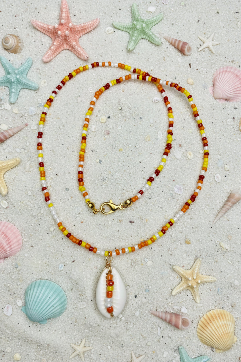 Necklace with a teardrop-shaped pendant on a marble surface