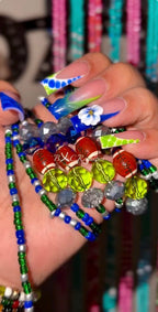 Colorful waist-beads with decorative nails held by me.