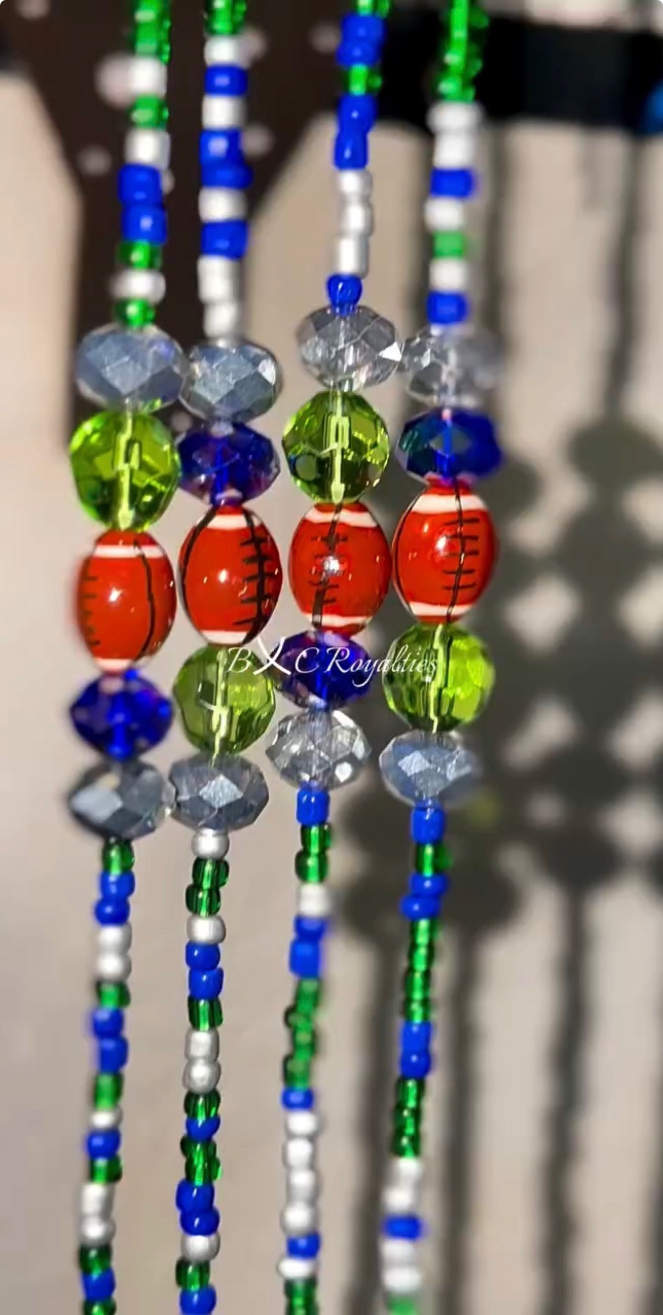 Colorful beaded strands with various beads on a blurred background
