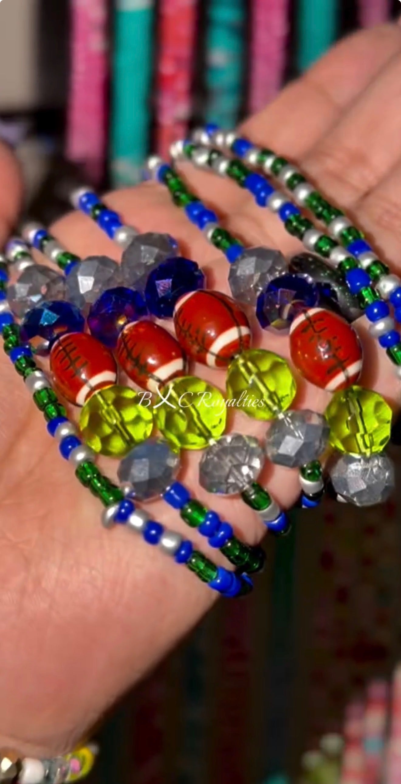 Colorful beaded bracelets on a hand with a blurred background