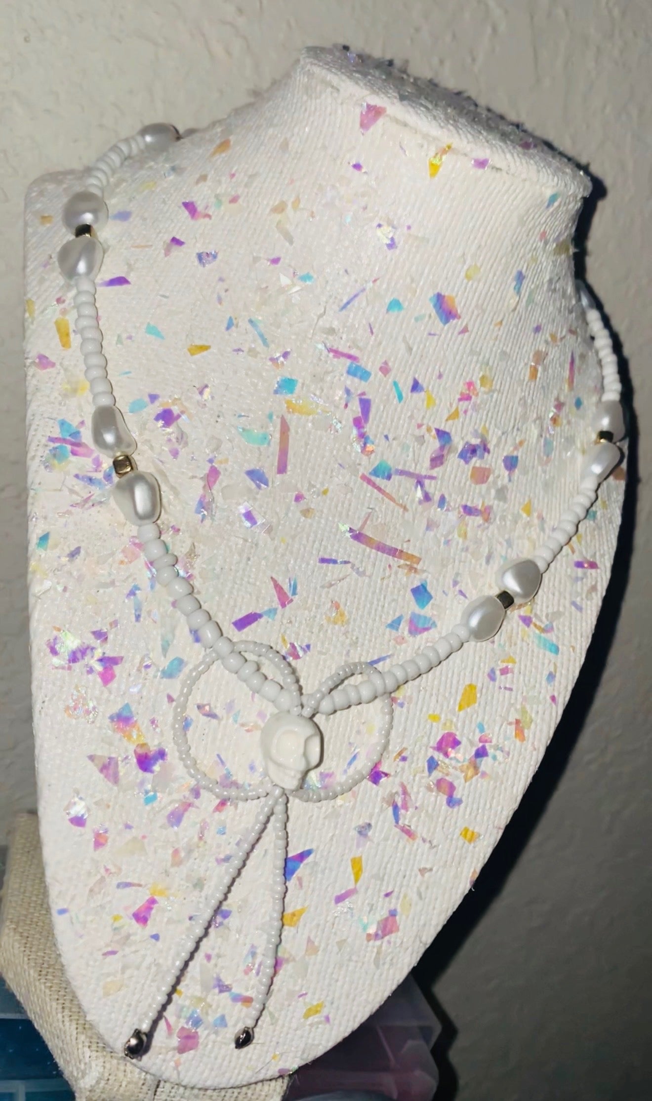 White headband with colorful sprinkles on a plain background