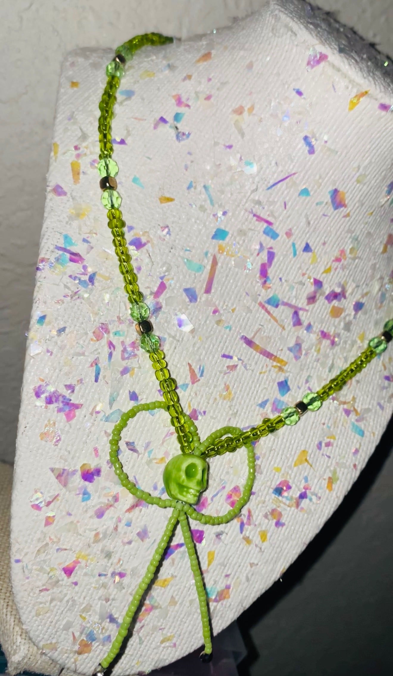 Mist Green beaded necklace on a textured fabric surface