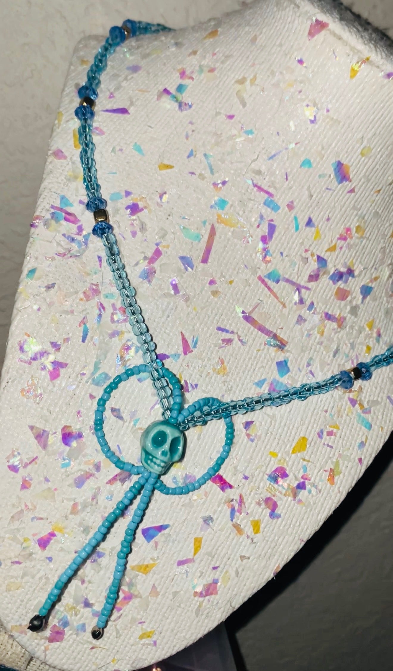 Baby Blue knotted cord on a textured surface with colorful confetti