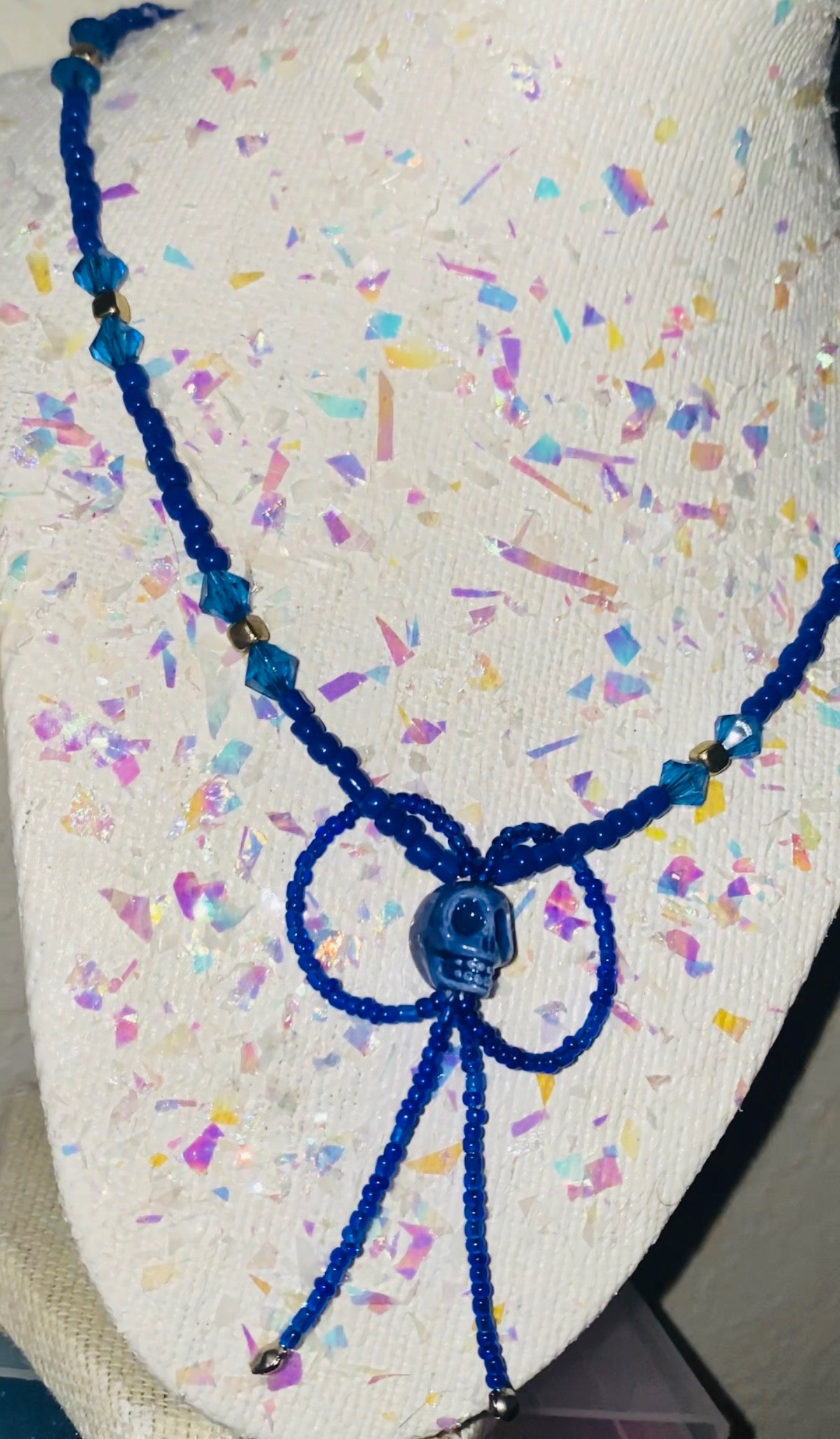 Navy Blue beaded necklace on a colorful speckled surface