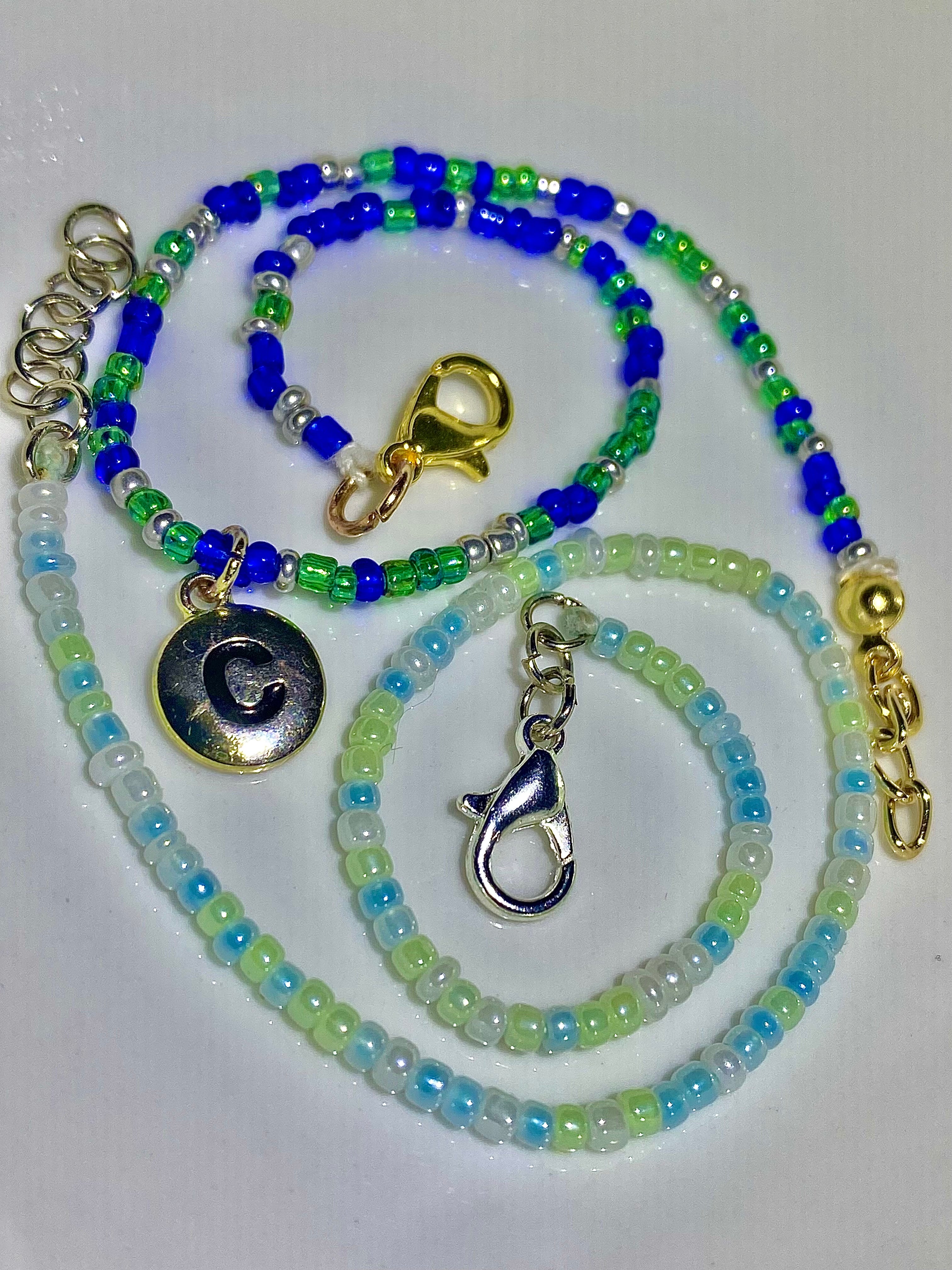 Two beaded lanyards with charms for couples on a white background