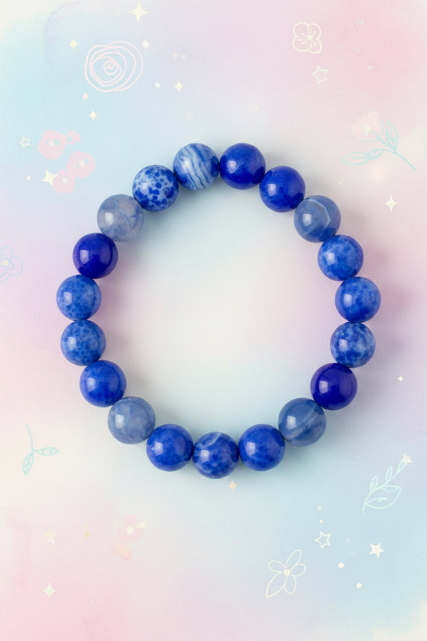 Blue beaded bracelet on a marble surface