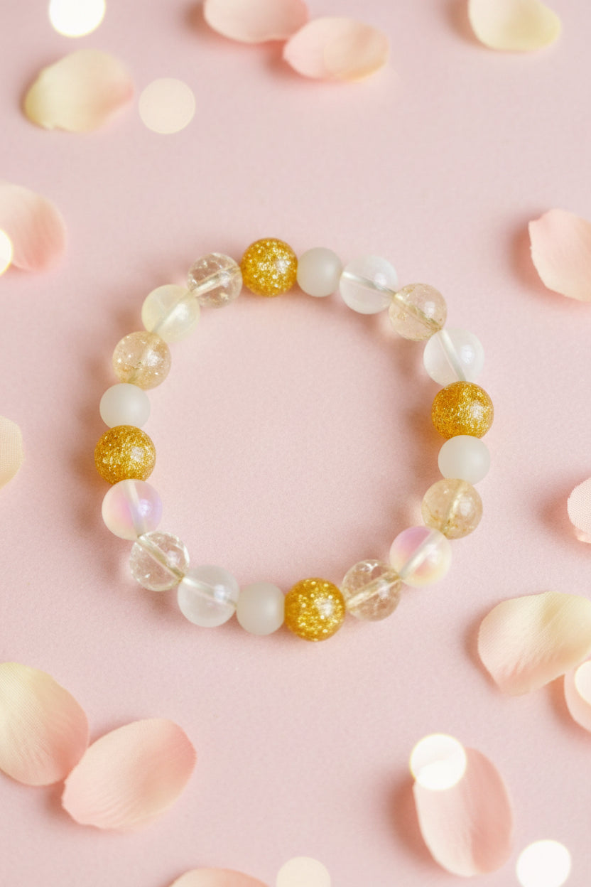 Bracelet  with gold and white beads on a marble surface