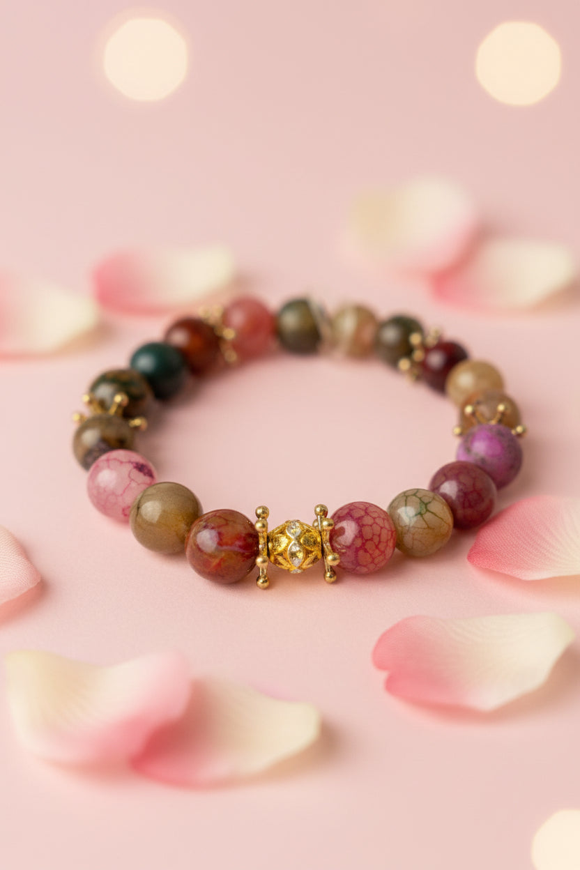 Multicolored beaded bracelet on a marble surface, add gold stone