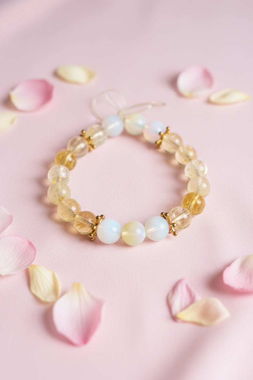 Beaded bracelet with clear yellow and white beads on a marble surface, add gold star