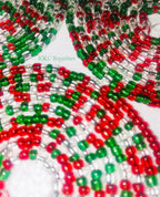 Close-up of red, green, and clear beaded strands with 'BXC Royalties' branding.