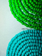 Two strands of green and turquoise beads on a light background with 'BXC Royalties' branding.