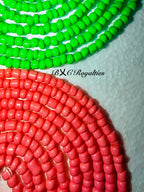 Two strands of beads, one green and one red, on a white background with 'BXC Royalties' branding.