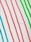 Colorful beaded strands in red, green, and blue on a white background